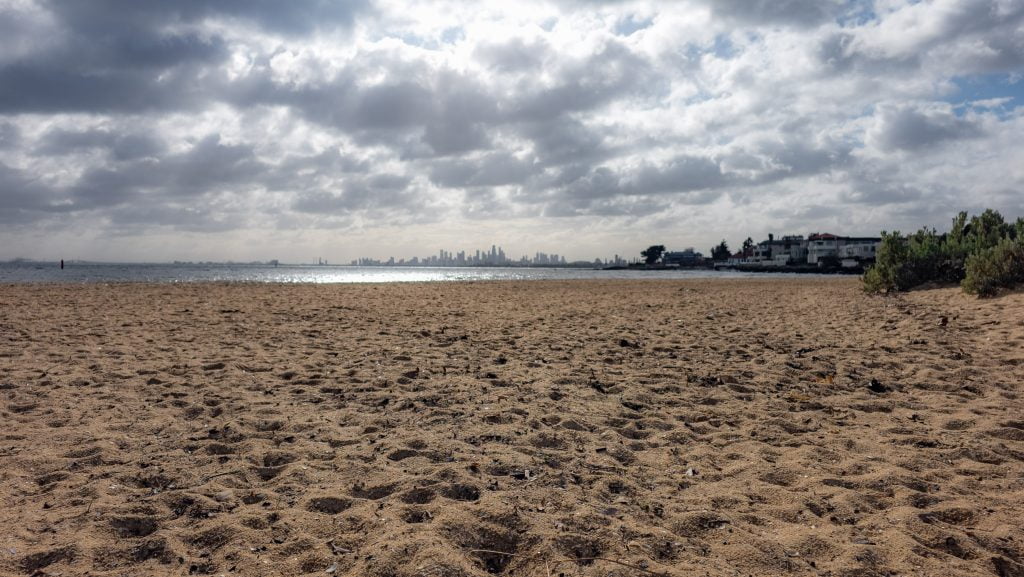 Sandy dog beach with Melbourne city views, Brighton Dog Beach